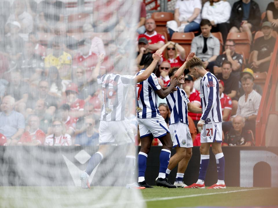 Isaac Price celebrates scoring a header against Wrexham with team-mates