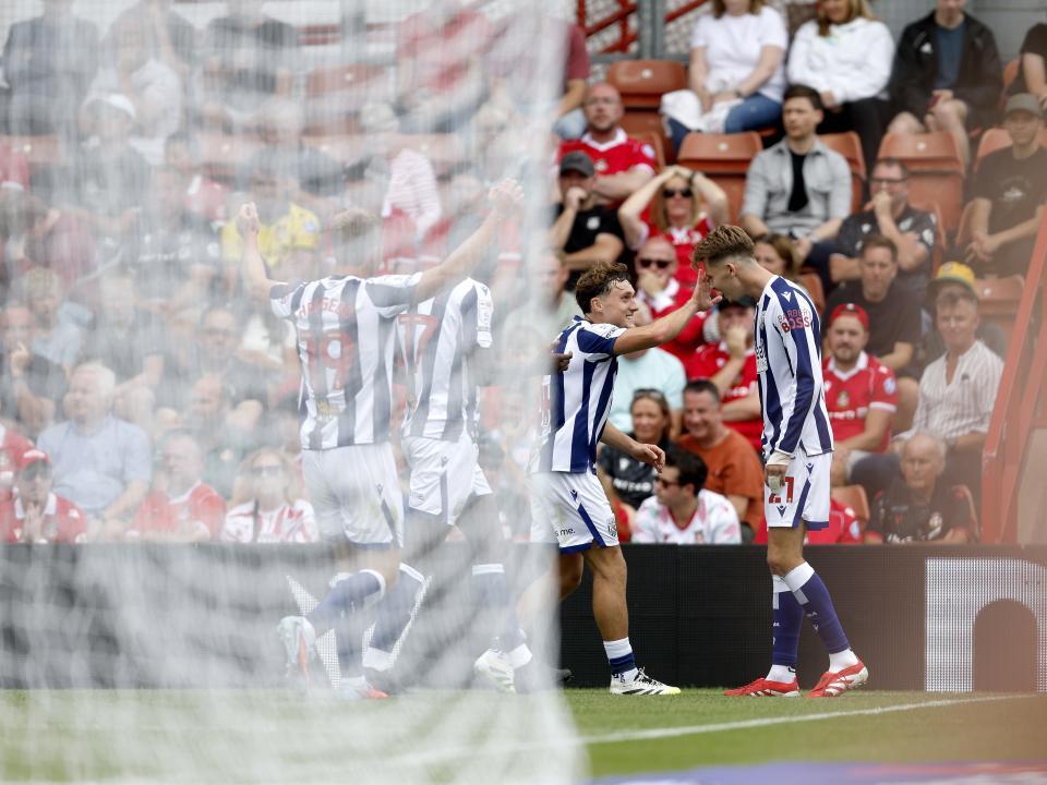 Isaac Price celebrates scoring a header against Wrexham with team-mates