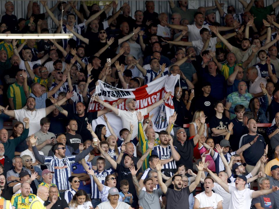 A general view of WBA fans celebrating in the stand at Wrexham 