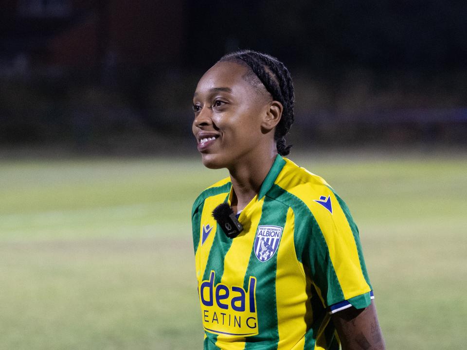 Amya Hammond-McLean is interviewed after a game in the yellow and green kit 