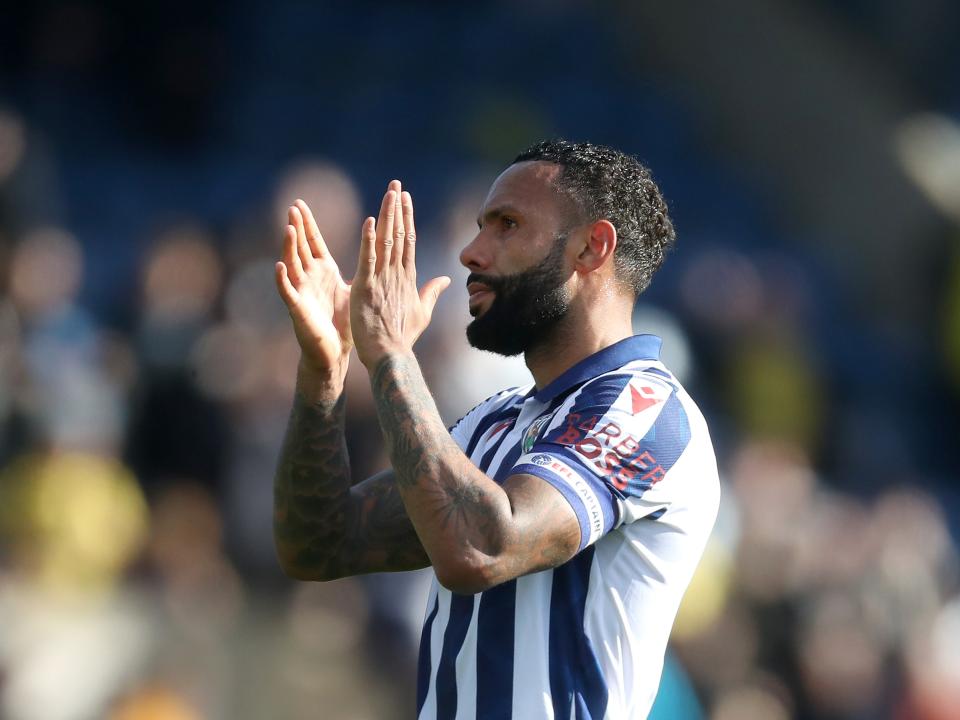 Kyle Bartley clapping WBA fans while wearing a home shirt 
