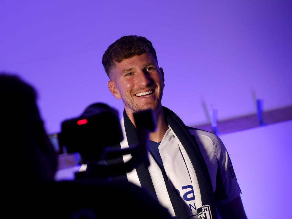 Chris Mepham smiling while being filmed by WBA TV 
