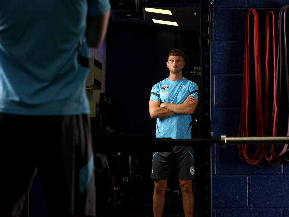 Chris Mepham folding his arms while looking in the mirror