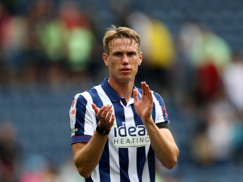 An image of Torbjorn Heggem applauding Albion supporters