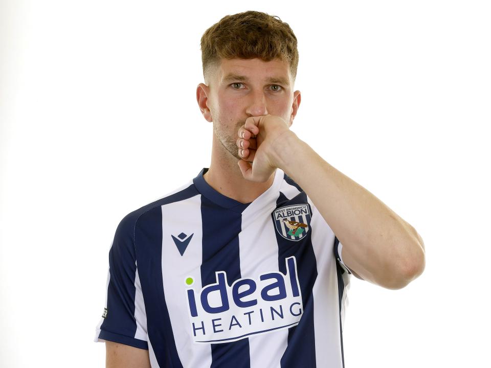 Chris Mepham in the home kit kissing his wedding ring and looking at the camera