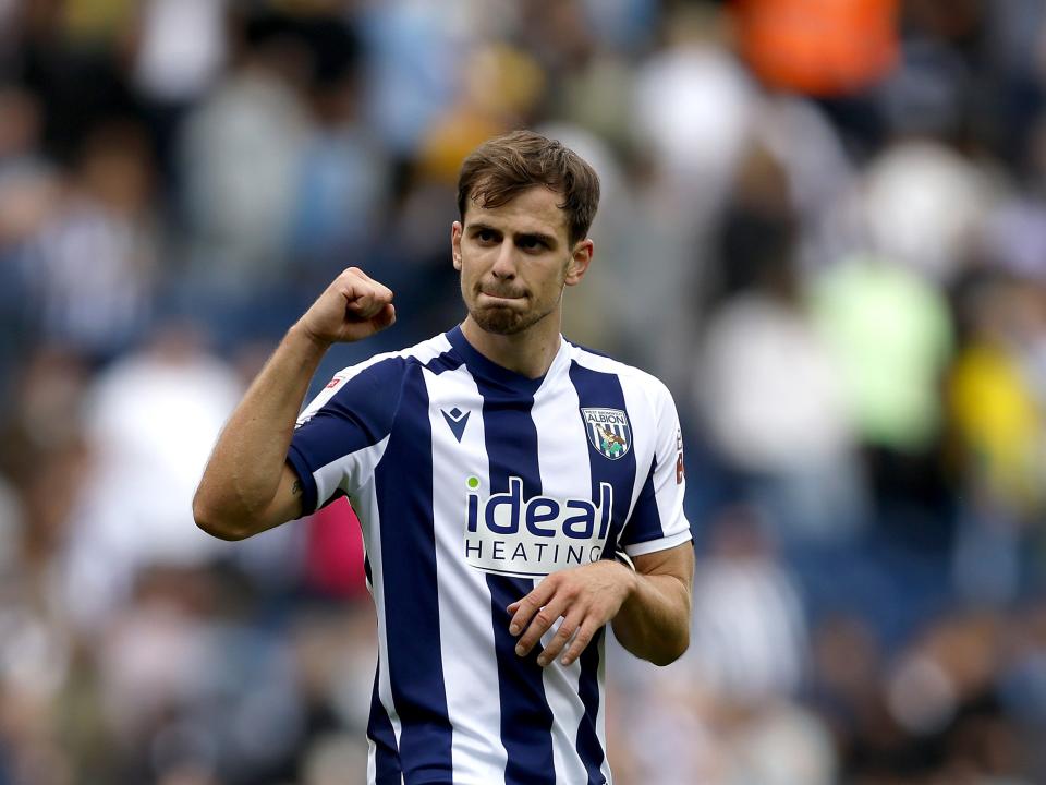 Jayson Molumby fist pumps towards the crowd in the home kit 