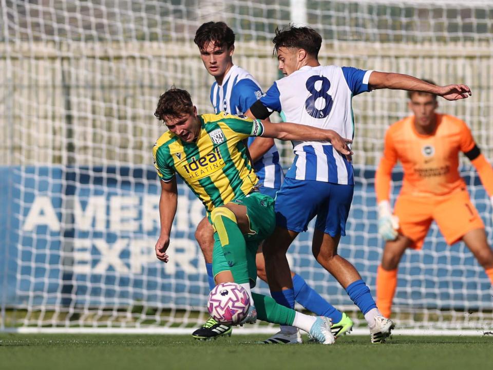 A photo of U21 midfielder Cole Deeming in the 2025/26 yellow and green away kit