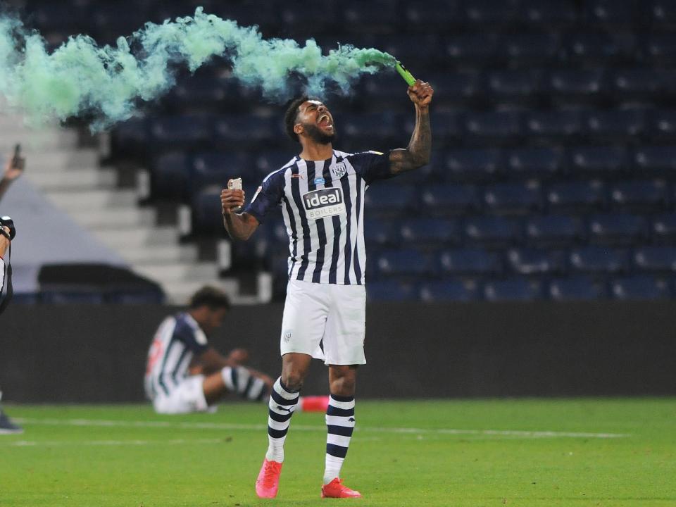 Darnell Furlong celebrating as Albion secure promotion.