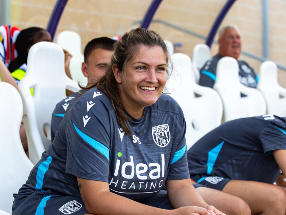 Siobhan Hodgetts-Still sat down in the dugout at Loughborough Lightning smiling 