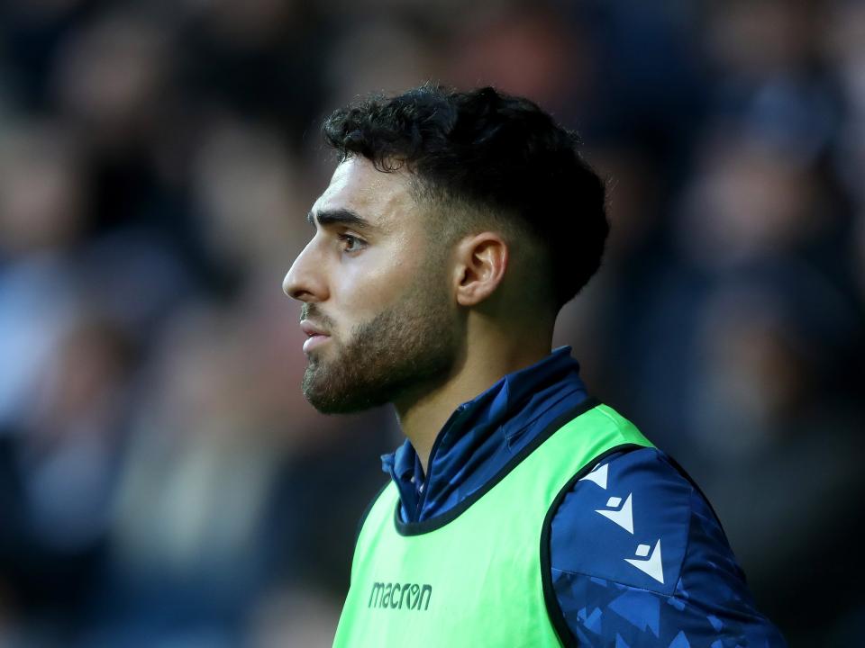 A side-on shot of Tammer Bany wearing a green bib