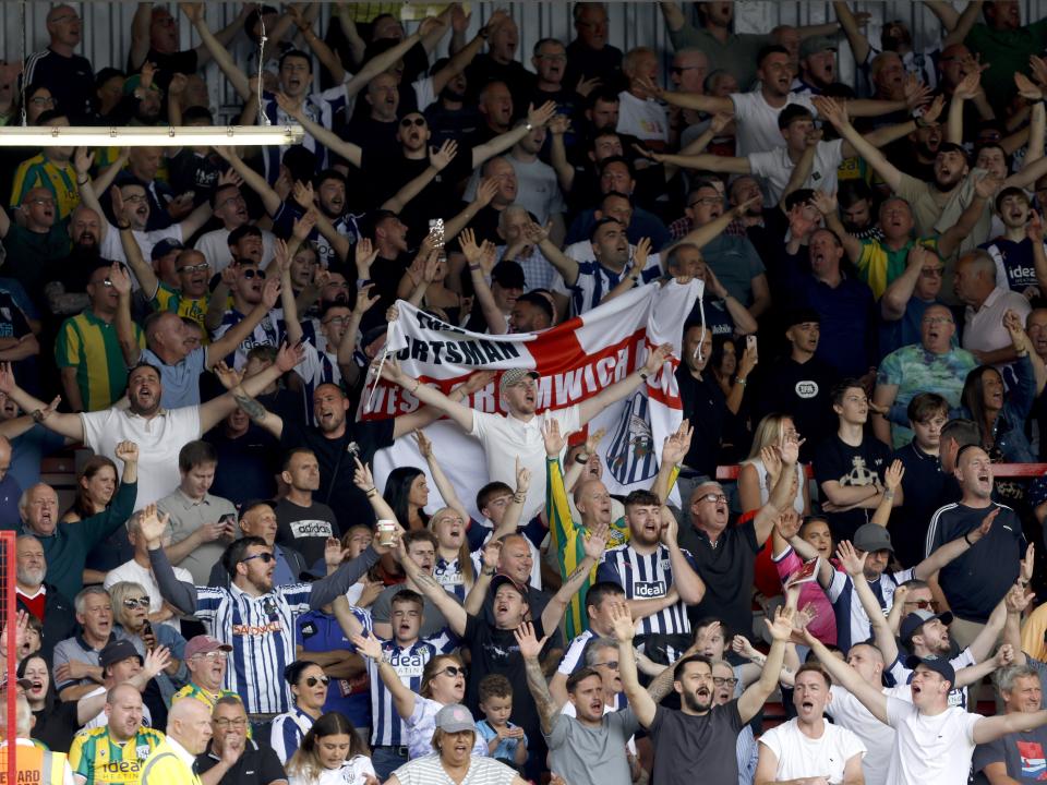 A general view of WBA fans cheering at a game in the stand 