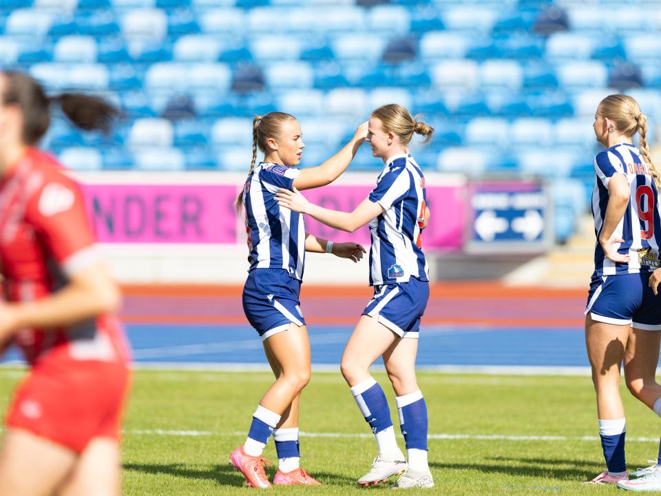 Phoebe Warner high-fives Seren Watkins.