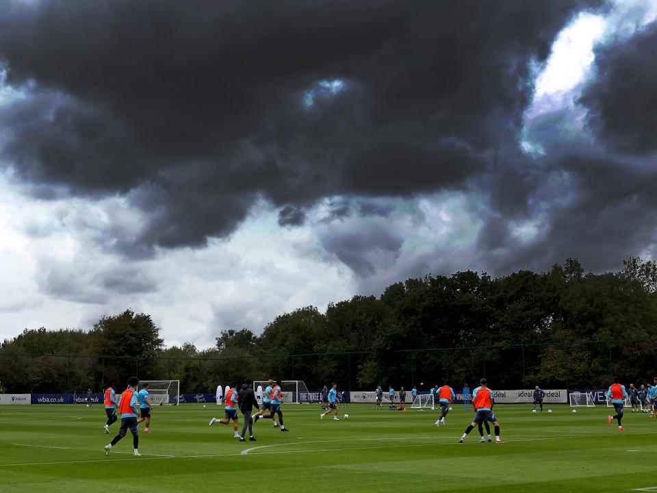 A general shot of training with plenty of players in shot and stormy skies above