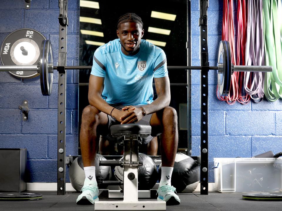Samuel Iling-Junior smiling at the camera while sat down in the gym