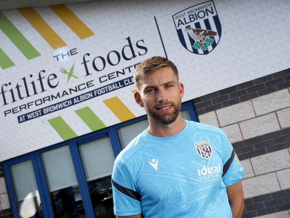 Charlie Taylor smiling at the camera while stood outside the front of the training ground 
