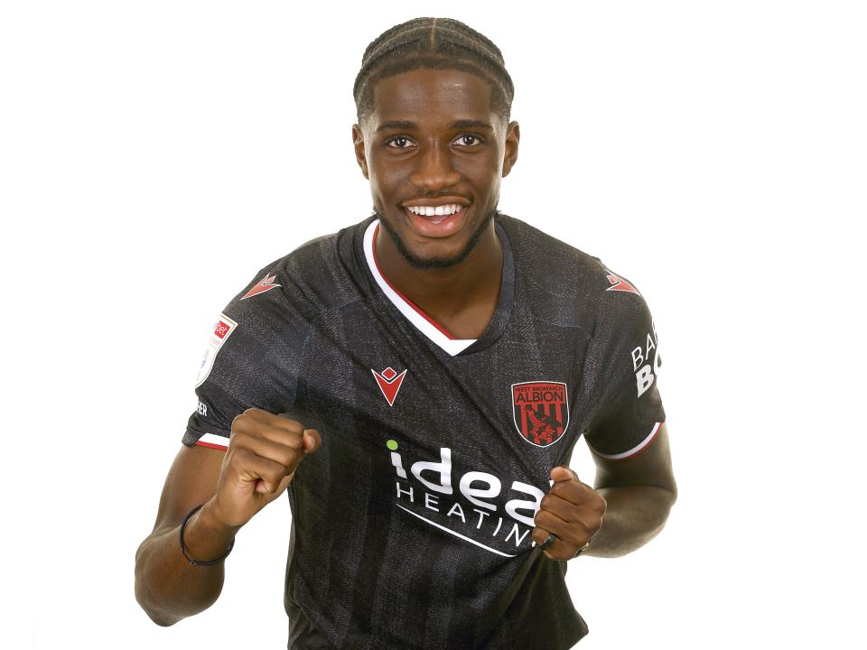 Samuel Iling-Junior posing for a photo in the black kit in front of a white background