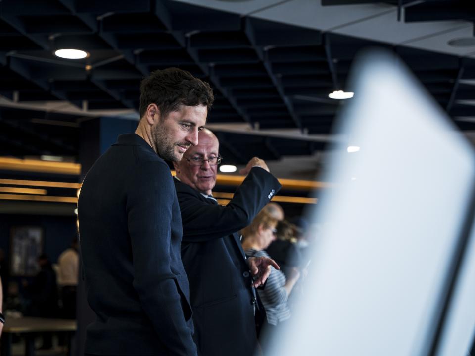 Ryan Mason looking at all the memorabilia and a specially curated gallery of 125 iconic Hawthorns images