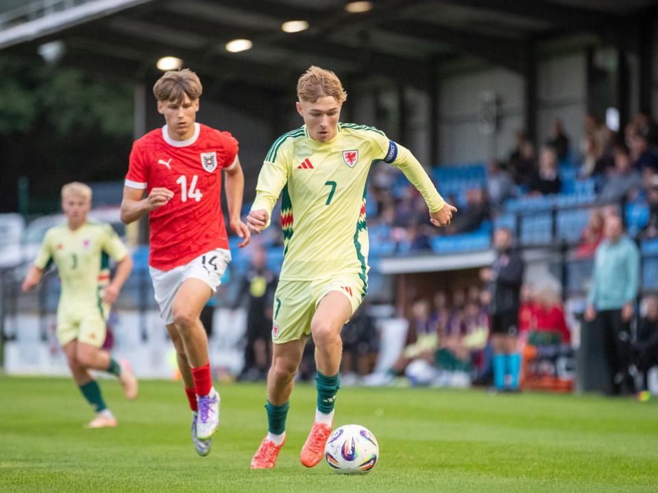 A photo of Albion youngster Ollie Bostock in the Wales yellow away kit
