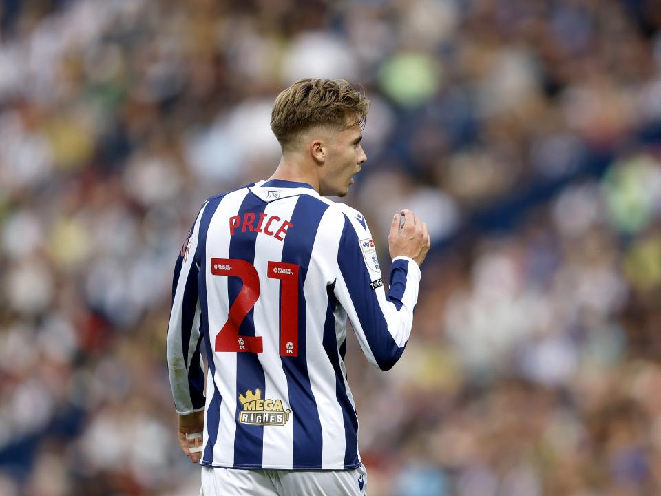 Isaac Price facing away from camera with his name and number on display during a game in the home kit 