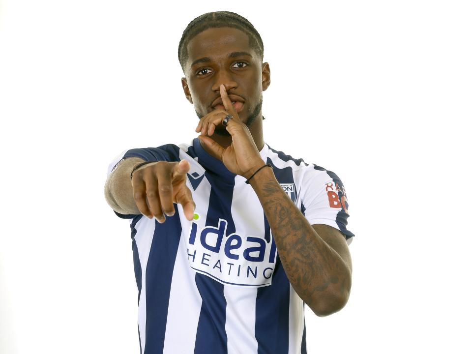 Samuel Iling-Junior posing for a photo in the home kit in front of a white background