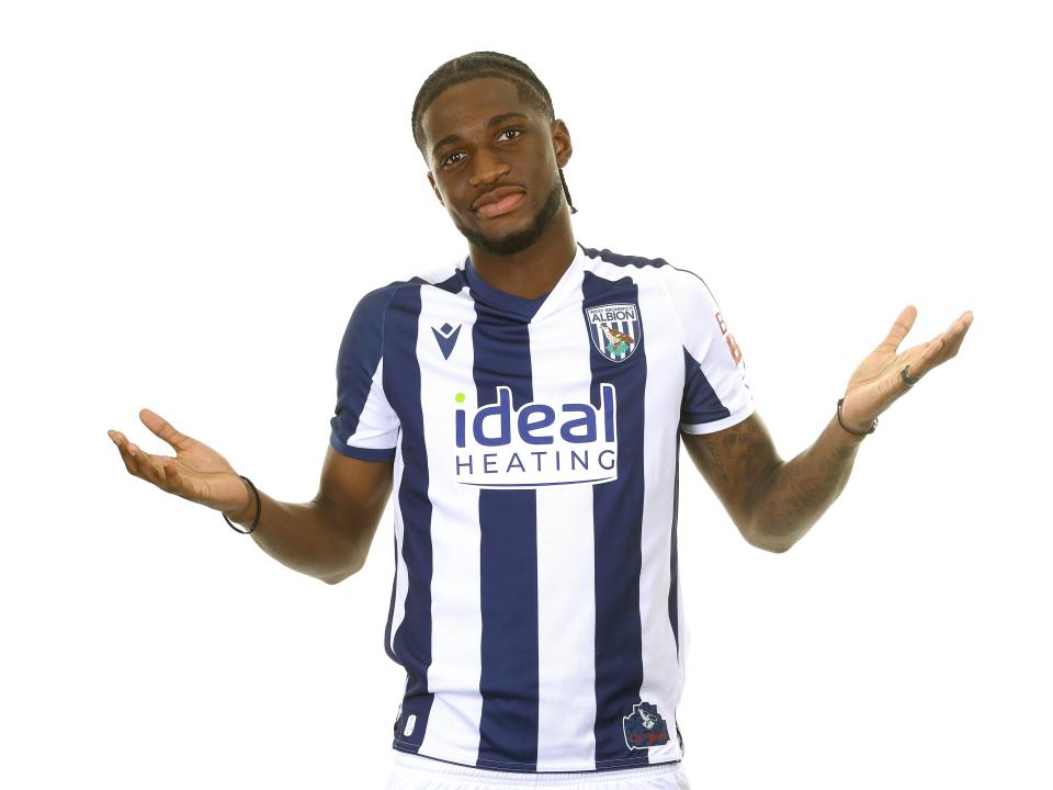 Samuel Iling-Junior posing for a photo in the home kit in front of a white background