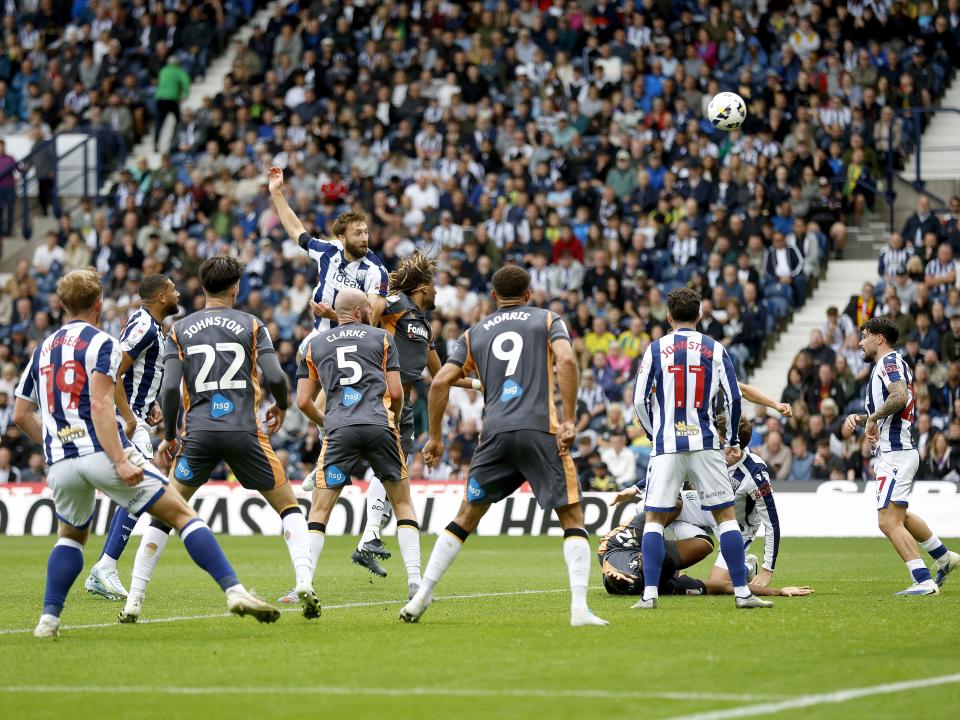 An image of Nat Phillips heading the ball against Derby