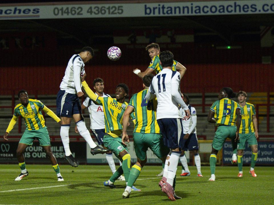 General action of players trying to win a header in the PL2 game between Spurs and WBA 