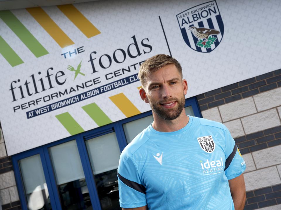 Charlie Taylor smiling at the camera while stood outside the front of the training ground 