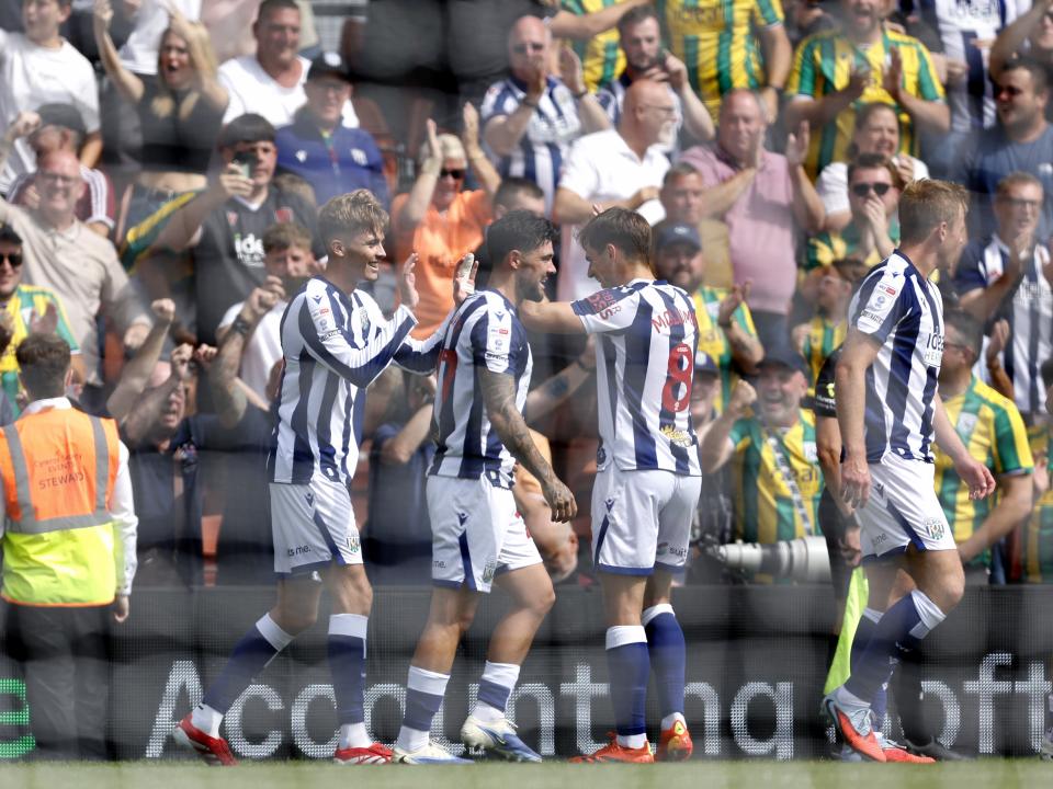 An image of Isaac Price celebrating a goal with his teammates