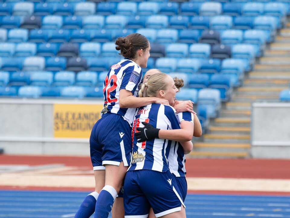 A photo of the women's team celebrating 