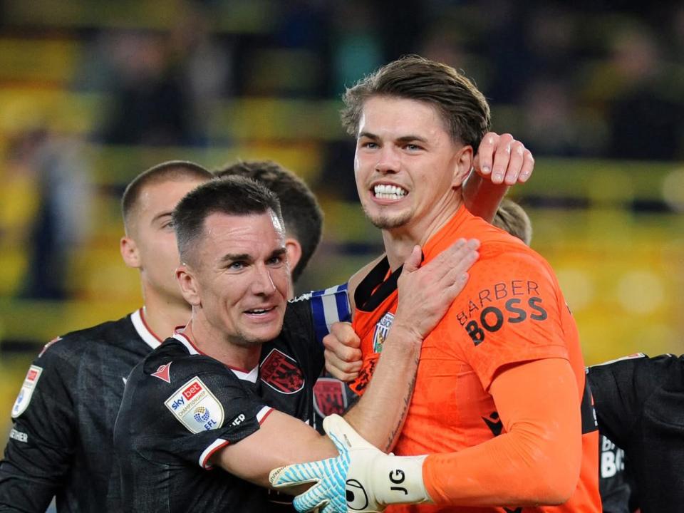 Josh Griffiths and Jed Wallace embrace after beating Norwich 