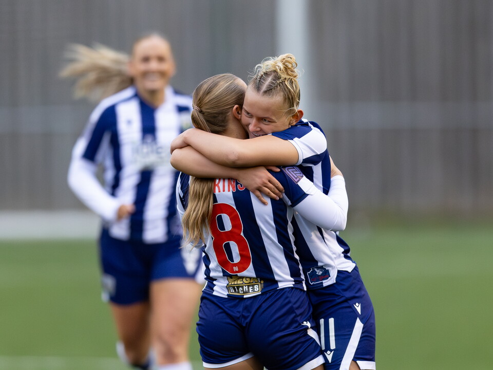 A photo of the women's team celebrating a goal 