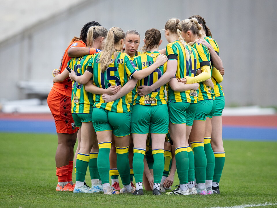 Albion Women in a team huddle.