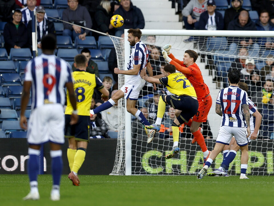 Nat Phillips heading the ball away against Oxford 