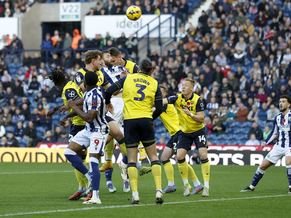 Several WBA & Oxford players jumping for the ball 