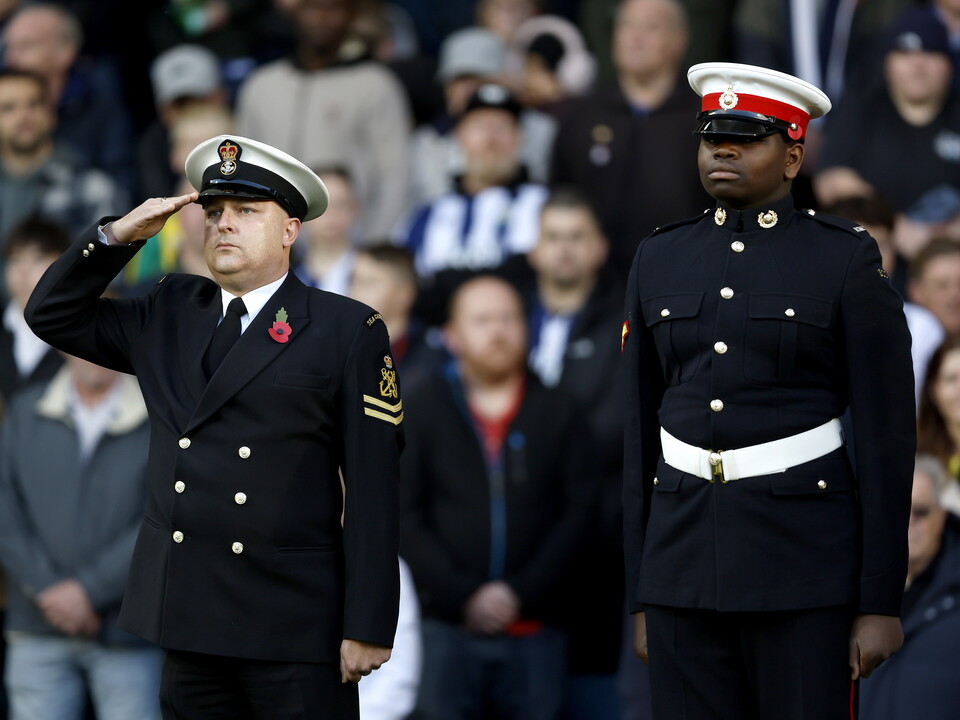Servicemen standing to attention before the WBA vs Oxford game