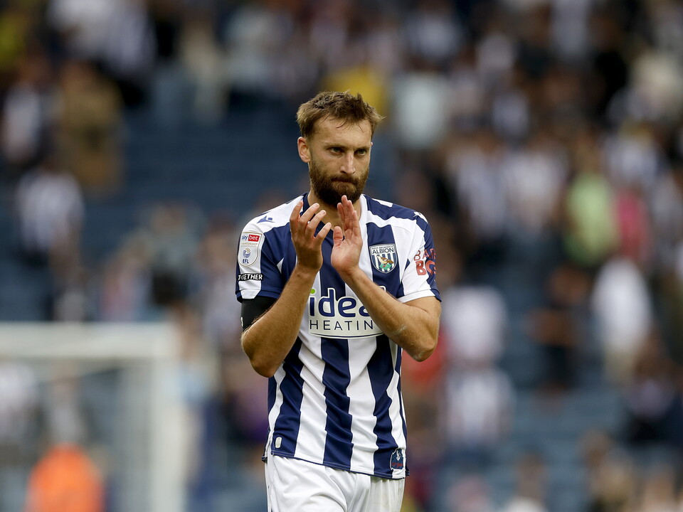 Nat Phillips applauding WBA fans while in a home shirt 