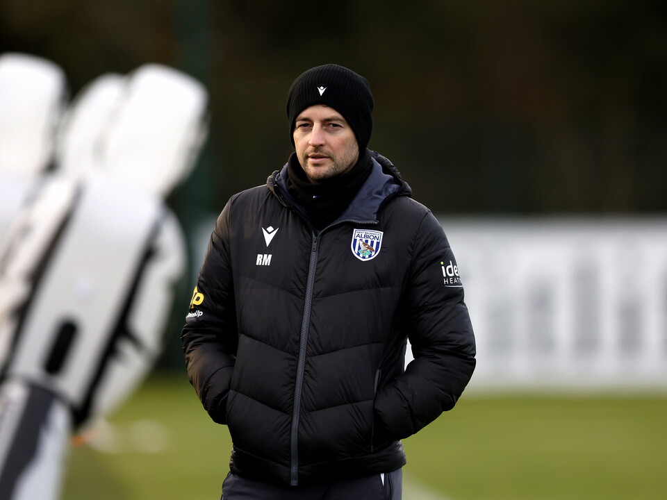 Ryan Mason watching training with a hat on