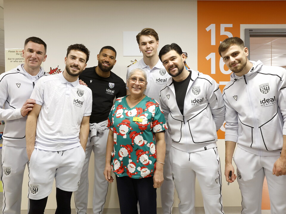 Several WBA players posing for a photo with an NHS worker on a ward at the Midlands Met hospital 