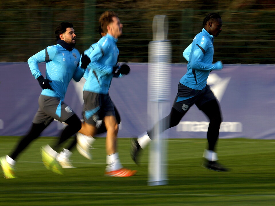 Three players running forward in a line during a training session