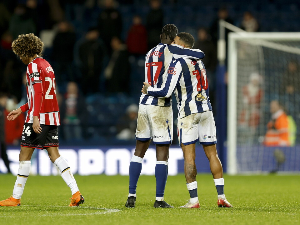 Ousmane Diakité and Karlan Grant hug on the pitch after beating Sheffield United 