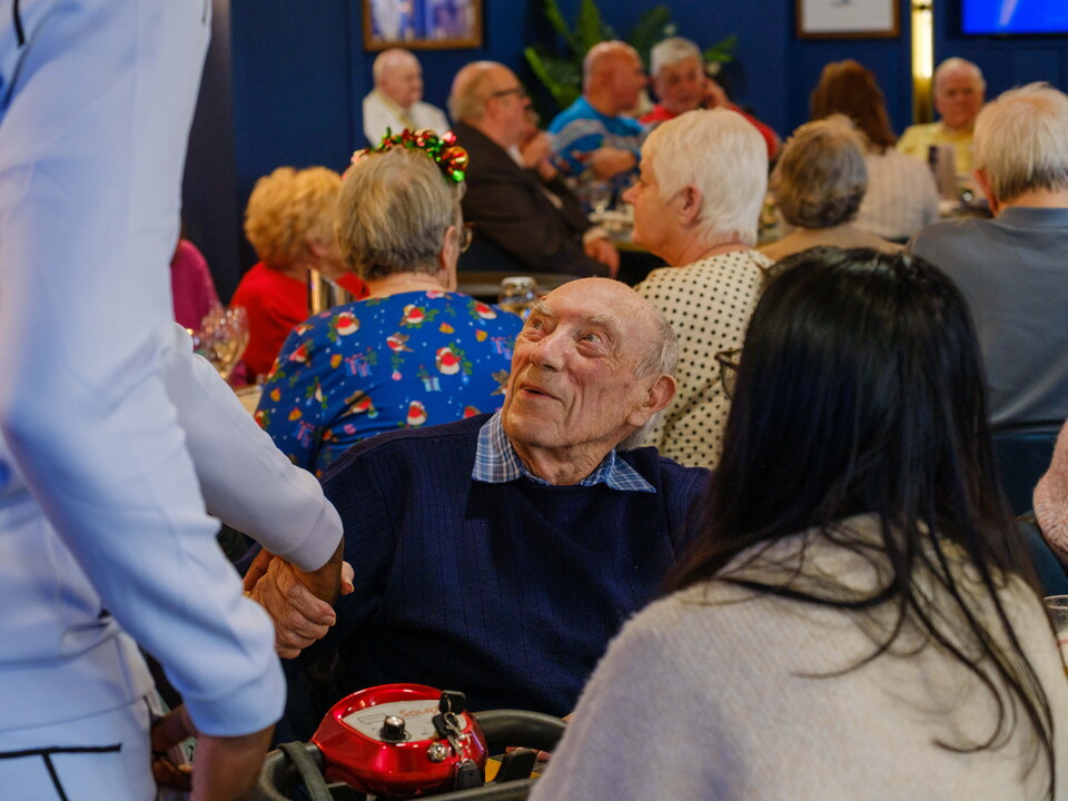 Hawthorns Hub participant greeting a scholar.