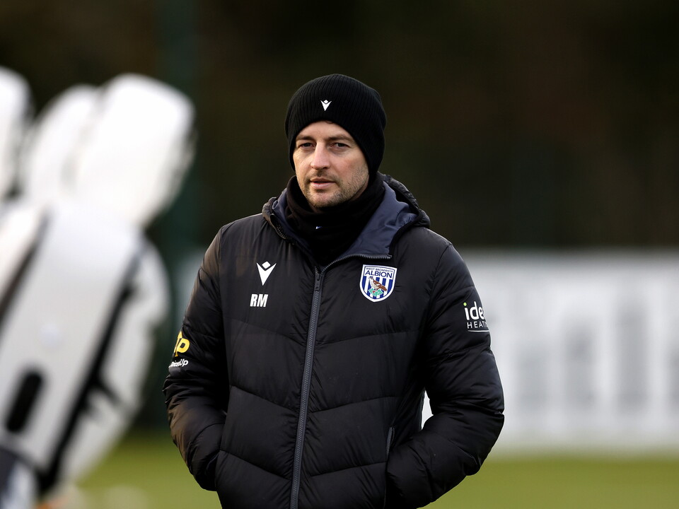 Ryan Mason wearing a coat and a hat during a training session
