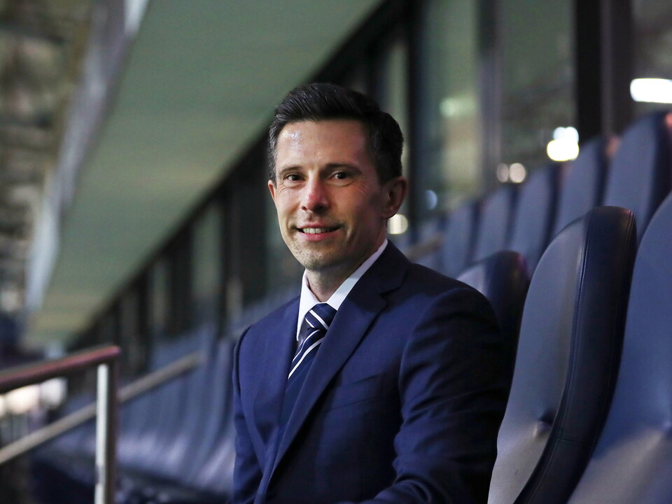 Andrew Nestor sat in a suit smiling at the camera 