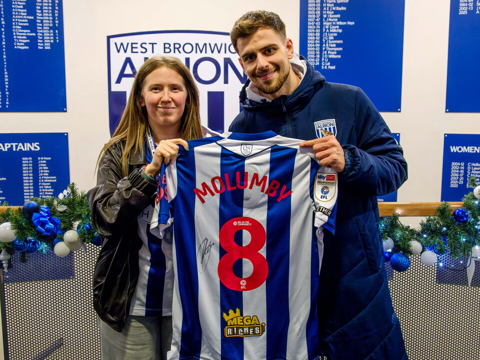 Jade Hopkins and Jayson Molumby holding his signed shirt inside The Hawthorns