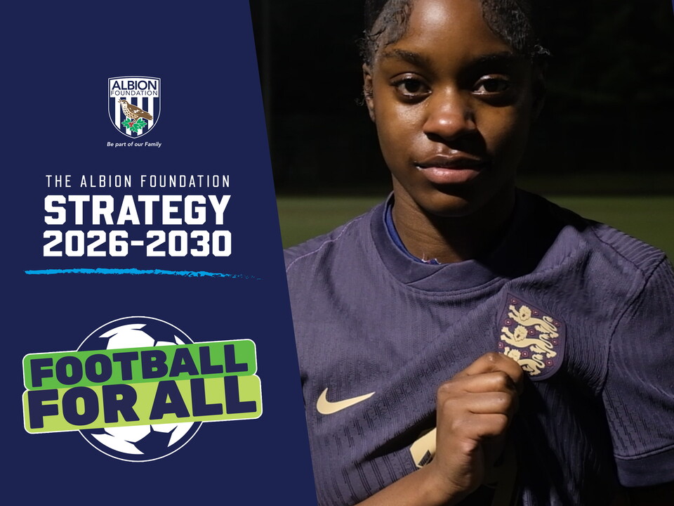 Player Asiah holding out the England badge on her shirt