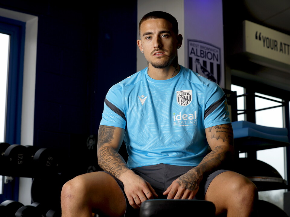 Danny Imray smiling at the camera while sat down in the gym