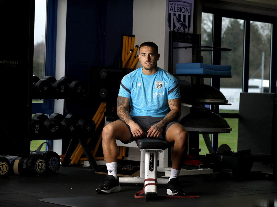 Danny Imray smiling at the camera while sat down in the gym