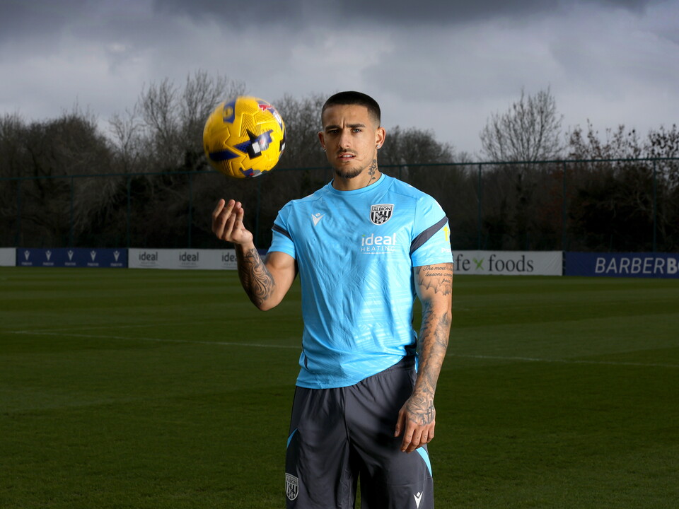 Danny Imray holding a football in his hands out on a training pitch