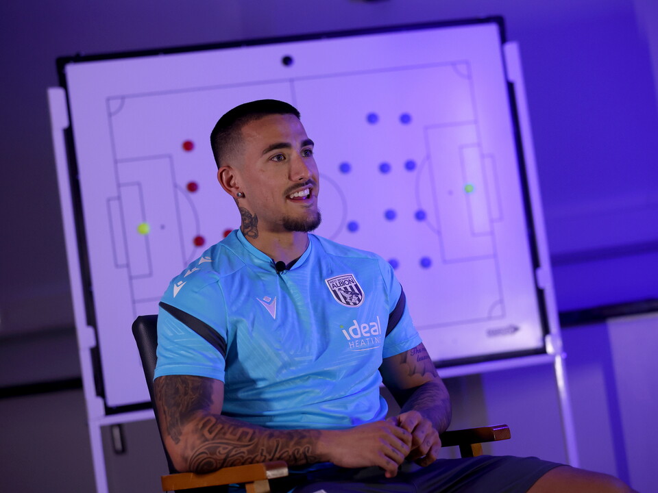 Danny Imray smiling while being interviewed by WBA TV while sat in front of a tactics board